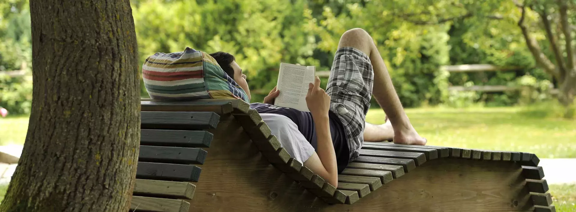im Garten auf einer Liege entspannen und ein Buch lesen