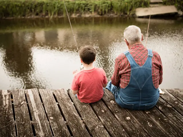 Happy Great Grandfather and Grandson Fishing Together