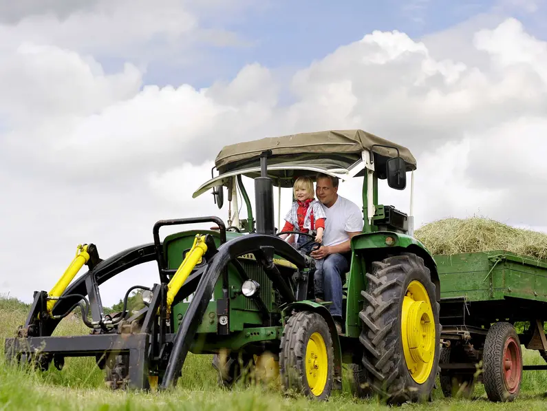 Bei einem Urlaub auf dem Bauernhof in Thüringen können Kinder auf dem Traktor mitfahren.