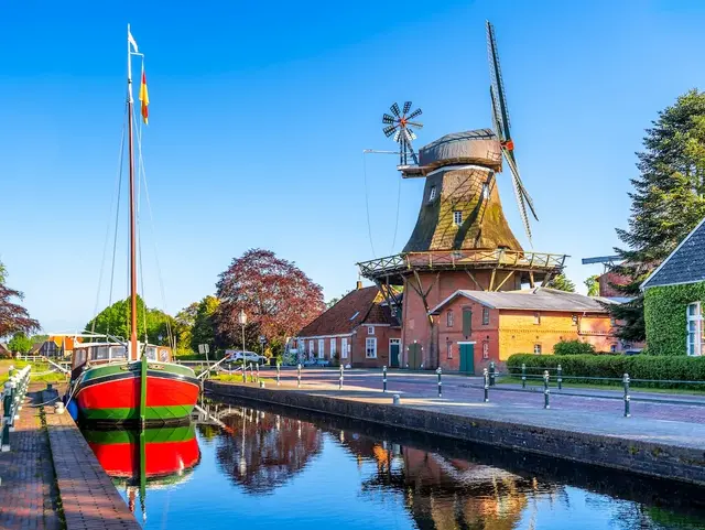 Kanal mit Bot und Mühle im Hintergrund, Gallerieholländer, Westgrossefehn, Grossefehn. 