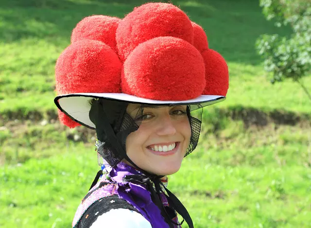 im Urlaub auf dem Bauernhof im Schwarzwald ein Mädchen mit traditionellem Bollenhut bestaunen