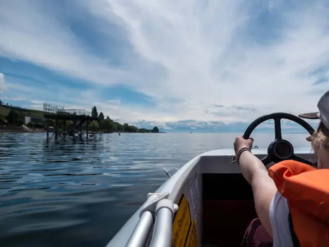 Girl steering a pedal boat on Lake Constance, Germany