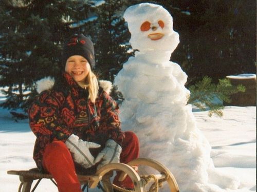 Kind mit Schneemann und Schlitten Kind mit Schneemann und Schlitten