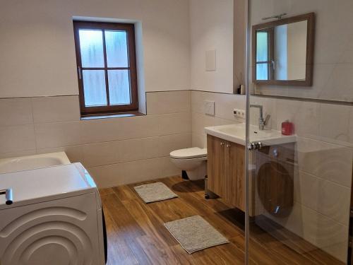 Badezimmer mit Dusche, Badewanne und Waschmaschine