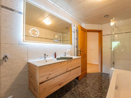 Großer, moderner Spiegel und viel Stauraum im unteren Badezimmer